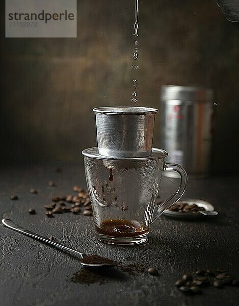 Food  Food  Preparation of Vietnamese coffe with aluminum cofe filer on dark background