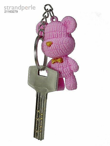 House keys with pink teddy bear isolated on white background