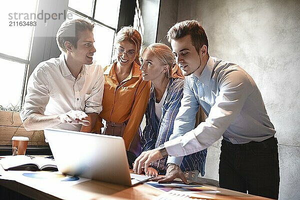 Group of colleagues having meeting in boardroom while working on big presentation and preparing their business strategy. Creative designers looking brainstorming solutions.Teamwork makes the dream work