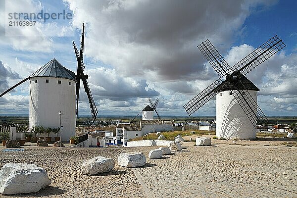 Three windmills in a village under a cloudy sky  Campo de Criptana  Ciudad Real province  Castilla-La Mancha  Don Quixote Route  Spain  Europe