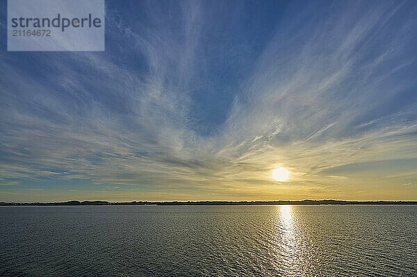 Sunrise over the calm sea  with wide sky and soft clouds in warm light  Bergen  Vestland  Norway  Europe