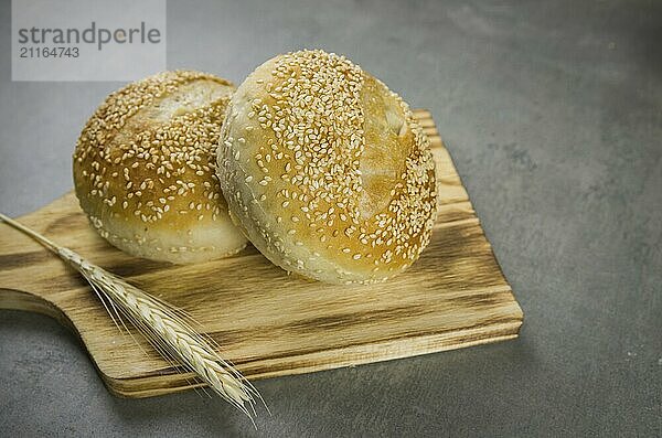 Beautiful Sourdough bread on gray background with dried wheat flower