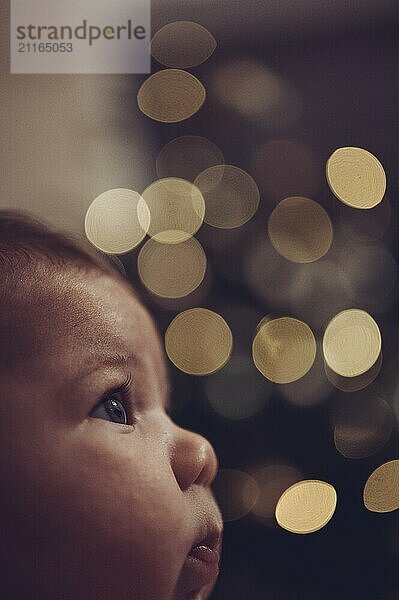 Close-up of a baby with blurred points of light in the background