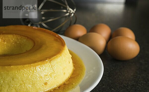 Traditional Brazilian dessert  milk pudding on dark background