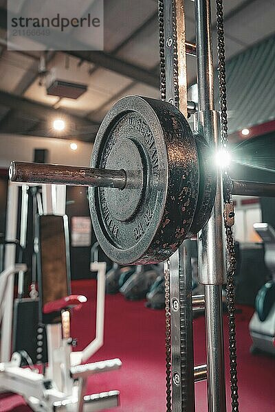 Dumbbell bar with weights on a machine in a fitness studio. In the background red floor  historic fitness studio  Bulls Fit  Mannheim  Germany  Europe