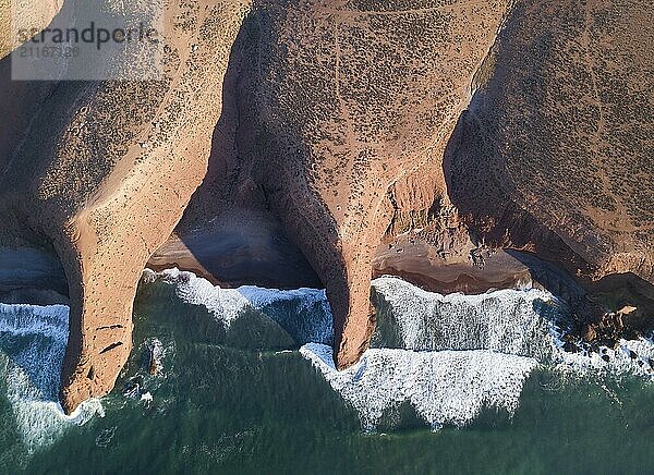 Aerial top view on Legzira beach with arched rocks on the Atlantic coast at sunset in Morocco