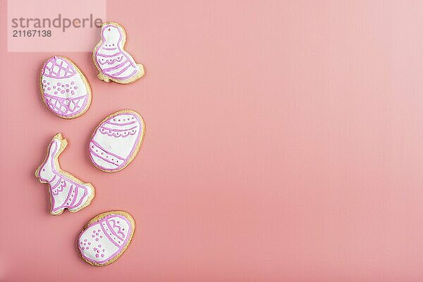 Homemade Easter cookies on pink background flat top view