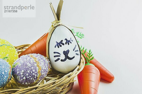 Happy easter bunny egg and eggs colored eggs in a basket isolated on a trendy white background. Minimal easter concept. Easter card with copy space for text