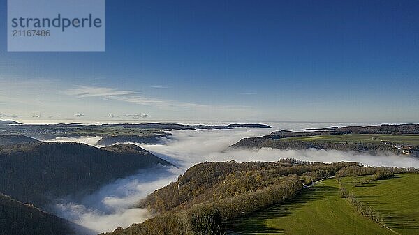 Thick fog fills a valley in late autumn