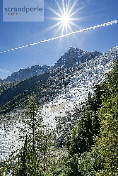 View of glacier Glacier des Bossons with sun star  behind summit of Aiguille du Midi  Chamonix  Haute-Savoie  France  Europe