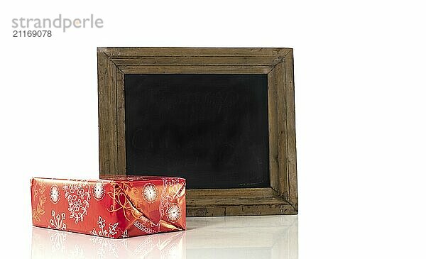 Blackboard and red present as gift isolated on white