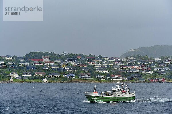 A fishing trawler at sea  in the background Alesund  Fylke  Norway  Europe