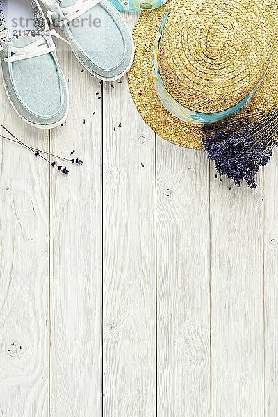 Straw hat  lavender flowers and fabric moccasins on white planks vacation planning background flat lay with copy-space