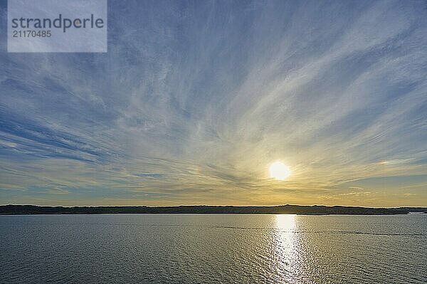 Sunrise over the calm sea  with wide sky and soft clouds in warm light  Bergen  Vestland  Norway  Europe