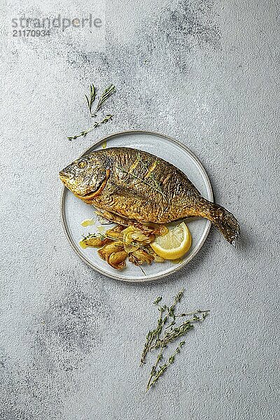 Food  Food  Grilled sea bream or dorada on gray plate. Gray background