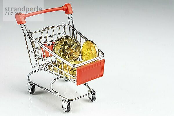 Bitcoin coin in a shopping cart on a white background