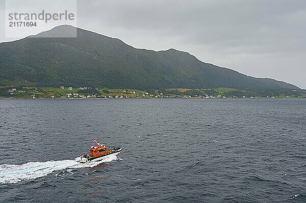 Pilot boat at sea  entrance to Alesund and island in the background  Alesund  Fylke  Norway  Europe