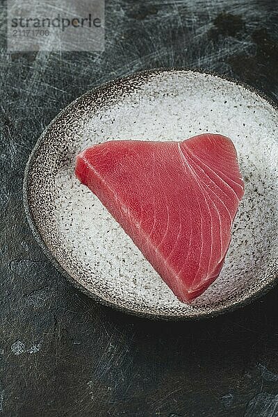 Food  Food  Raw fresh TUNA STEK on gray plate. Black background