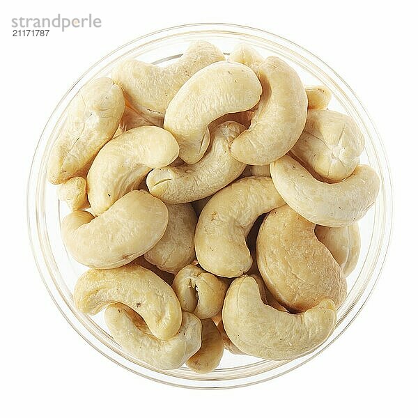 Cashew nuts in glass bowl isolated on white background flat lay closeup view