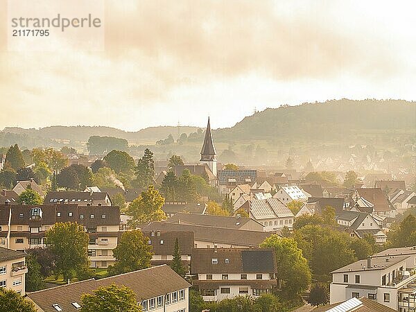 Village with church tower and many houses  hills in the background  morning fog  aerial view of the picturesque landscape  Calw  Black Forest  Germany  Europe