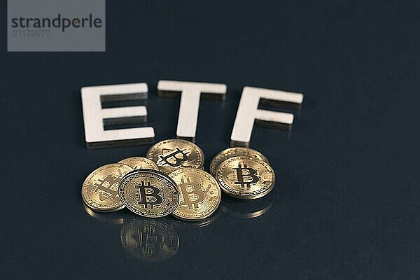 Bitcoin coins with ETF text put on dark background  Concept of the approval of Exchange Traded Fund