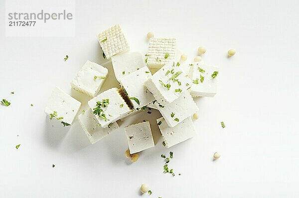 Soy Bean curd tofu with greens on white background Non-dairy alternative substitute for cheese