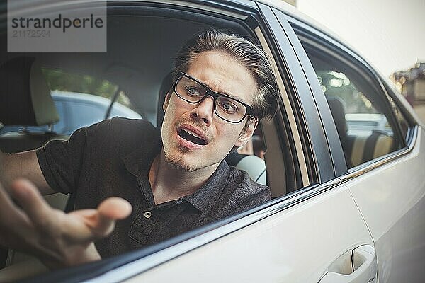 Accident. Young caucasian man driving a car shocked about to have traffic accident