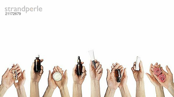 Female caucasian hands hold beauty cosmetisc products on white background