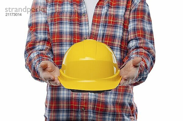 Caucasian laborer offers yellow hard hat in his hands on white background. Clipping path added