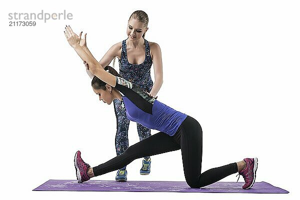 Sexy girls in sportswear doing fitness together isolated view on white background