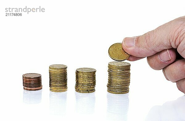 Man putting euro coin on stack money isolated on white