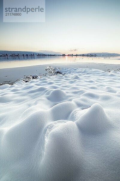 Snow-covered landscape with a view of a frozen lake at sunset  Seegarten  Allensbach  Lake Constance  Baden-Württemberg  Germany  Europe