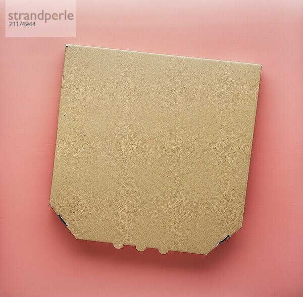 Pizza closed carton box on uniform pink background flat lay mockup with copyspace