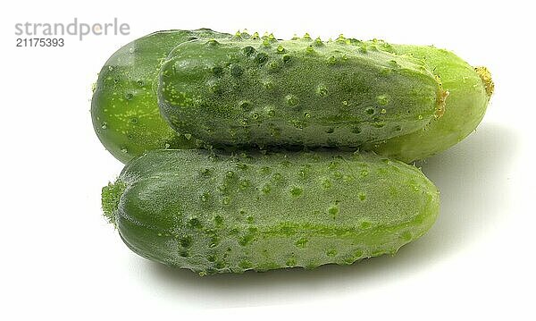 Three green gherkin cucumbers isolated on white background