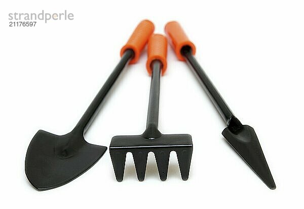 Three small gardening tools on white background