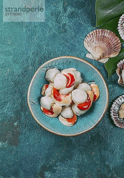 Food  Food  Raw fresh seafood shellfish scallops on blue background