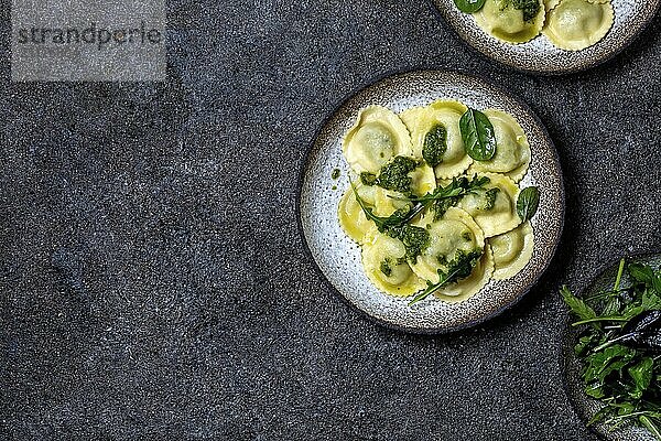 Food  Food  Italian spinach ricotta ravioli  Top view  black background  copy space  Vegetarian food  vegan ravioli