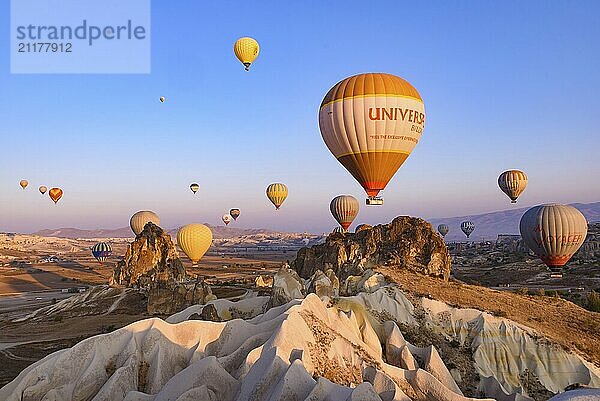 Flying hot air balloons and rock landscape at sunrise time in Goreme  Cappadocia  Turkey  Asia