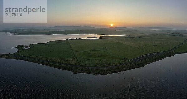 Stones of Stenness Circle and Henge  stone circle and ditch  neolithic monument  Loch of Stenness in front  Loch of Harray behind  UNESCO World Heritage Site  drone shot from outside the site  Mainland  Orkney Island  Scotland  Great Britain