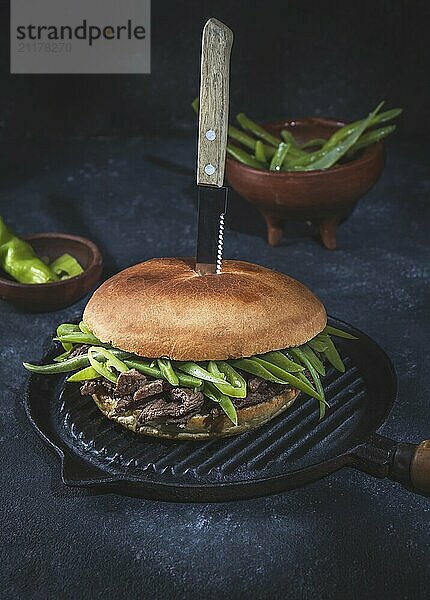 Food  Food  Chilean Latin american sandwich burger Chacarero with premium beef slices and green bean on black background