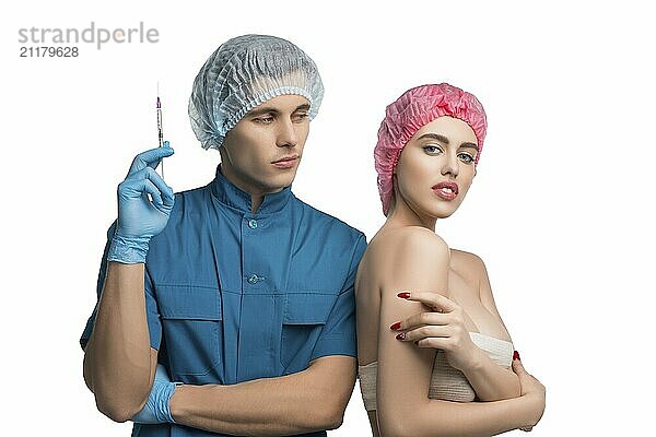 Plastic surgeon holding a syringe with his female pretty patient isolated cropped view on white background