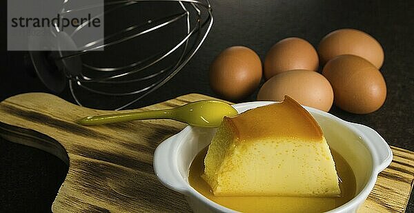 Traditional Brazilian dessert  milk pudding on dark background