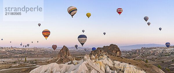 Flying hot air balloons and rock landscape at sunrise time in Goreme  Cappadocia  Turkey  Asia