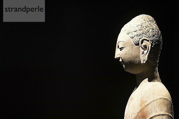 Turin  Italy  28 December 2023: Oriental Art Museum  Standing Buddha  Northern China  late 6th c. Copy space  black background  Europe