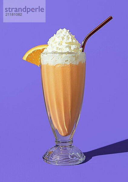 Glass of homemade milkshake with orange juice  vanilla ice cream and whipped cream. Delicious orange milkshake minimalist on a purple background