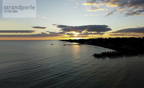 View of the city by the sea at sunset. Aerial view shot