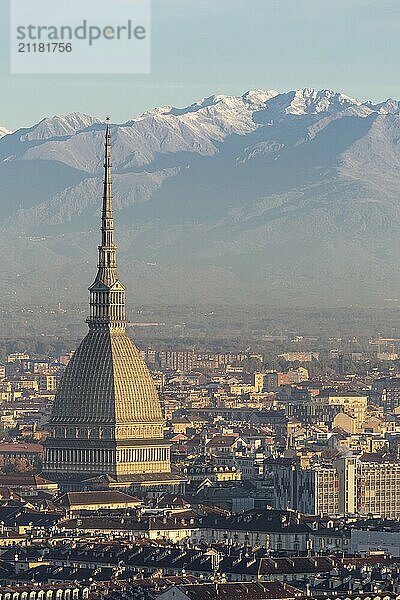 Turin  Italy  Circa November 2021: panorama with Alps and Mole Antonelliana  . Skyline of the symbol of Piedmont Region from Monte dei Cappuccini  Cappuccini's Hill. Sunrise light  Europe