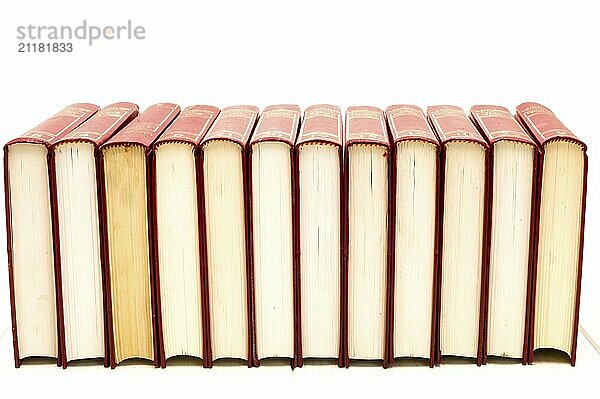 Red books flip over on a floor with white background