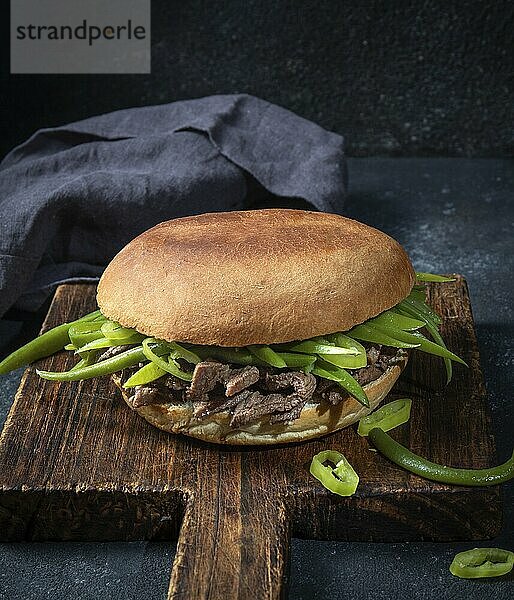 Food  Food  Chilean Latin american sandwich burger Chacarero with premium beef slices and green bean on black background