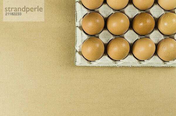 Beautiful fresh brown chicken eggs on brown background with copy space